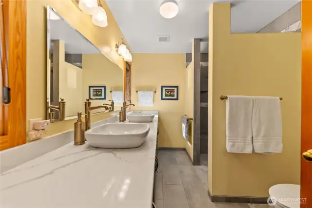 No waiting in line with a deluxe two sink vanity with gorgeous granite counters! Truly a walk-in shower with no edge. Extra wide hallways and doors accommodate aging in place!