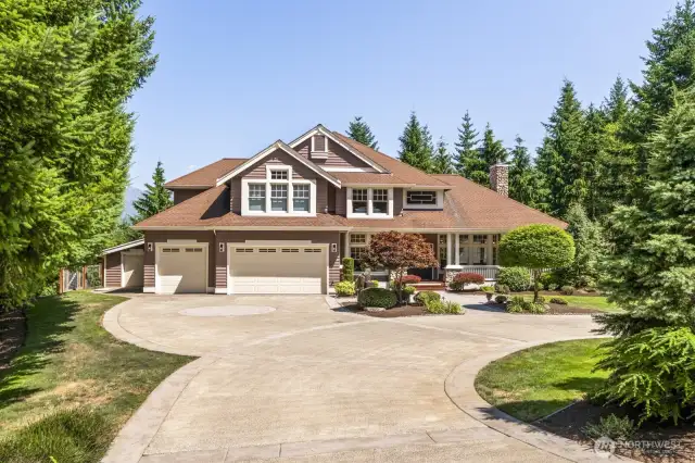 Oversized three-car garage includes a dedicated workshop area with built-in storage, plus a separate toy garage—perfect for all your gear and adventure vehicles.