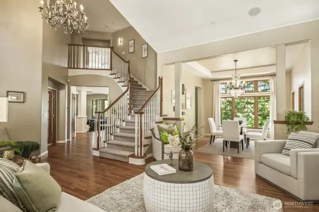 Newly refinished hardwood floors welcome you to the living room off the foyer, complete with a cozy gas fireplace.