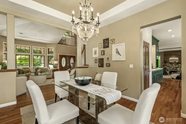 Spacious dining room filled with natural light from walls of professionally cleaned custom wood windows.