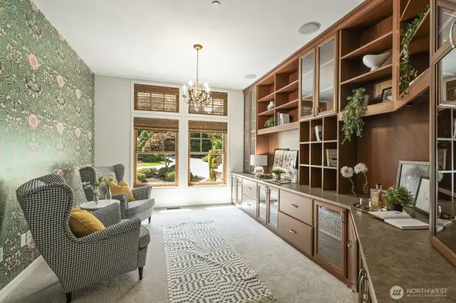Stunning library/office off the foyer with French doors, custom built-ins & blinds, designer wallpaper and new carpet.