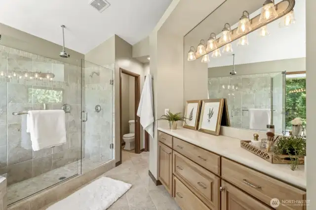 Beautifully designed primary 5-piece spa-like bath featuring a private toilet room, linen closet, rain shower, deep tub and extra vanity cabinet for added storage.