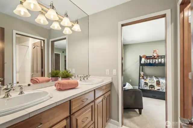 Jack & Jill bathroom thoughtfully connects Bedroom 1, the media room, and another bedroom—perfect for flexible living and guest comfort.