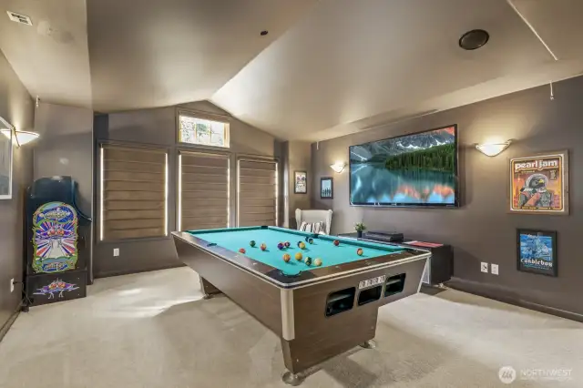 Spacious media lounge, featuring vaulted ceilings, surround sound & black out blinds.  Hang out for a game of PAC-MAN.  TV and pool table included for endless entertainment.