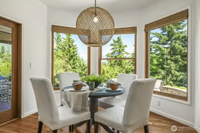 The eat-in breakfast nook off of the kitchen and family room offers generous space and opens directly to the covered patio for easy outdoor meals.