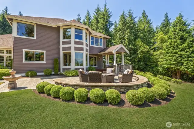 Impeccable landscaping and patio design add polish and presence to this stunning estate.