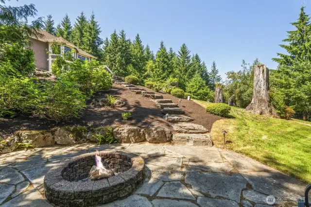 Charming stepped path leads to an additional fire pit area and expansive open space.