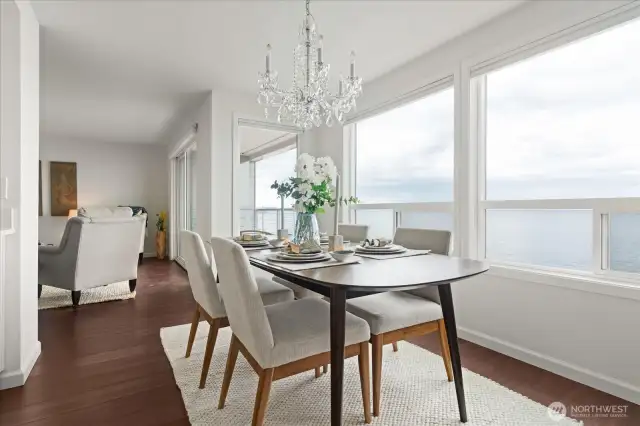 An all-occasion dining room with oversized windows and remote controlled blinds, illuminating the main living areas with natural light
