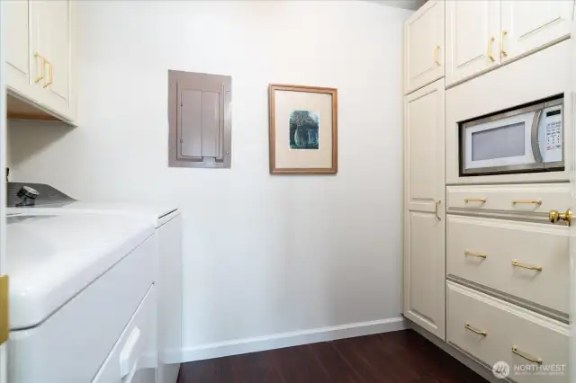 Wall of cabinets in pantry/ laundry room, with floor to ceiling pantry cabinet and deep storage drawers
