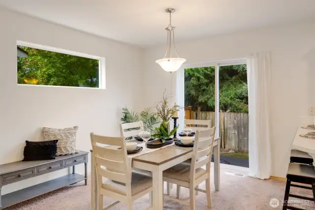 Natural light pours in through the sliding glass door, brightening the living space and offering easy backyard access.