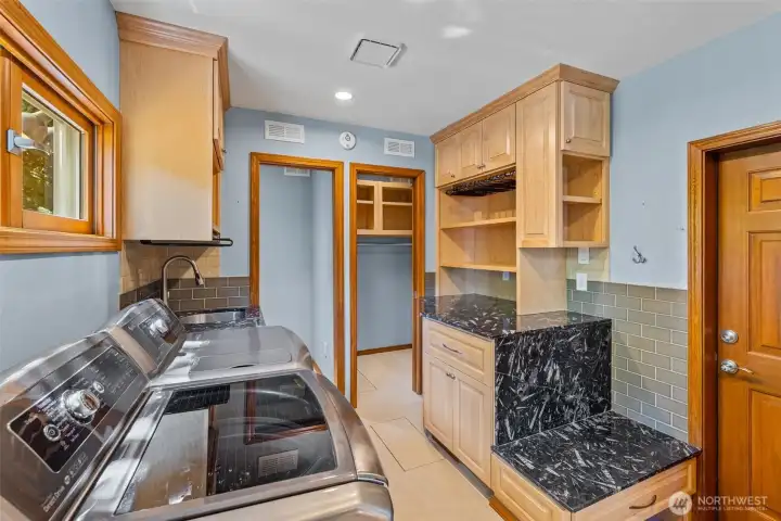 Fantastic laundry room/ mudroom with custom cabinets.
