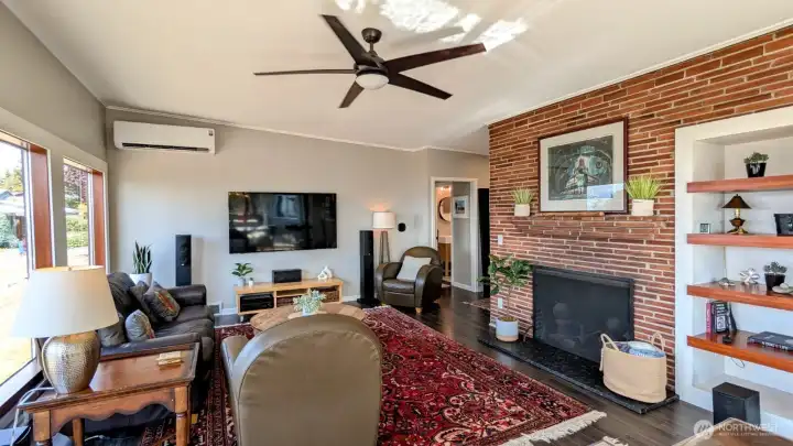 Living room with 6' windows, vaulted ceilings, built-ins, large fireplace and A/C for hot days!