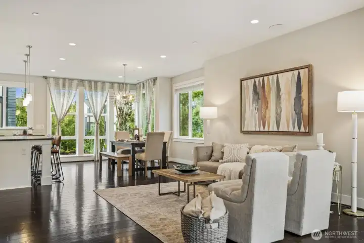 The living, dining, and kitchen areas are a single, seamless space with minimal walls to create a sense of flow and spaciousness.