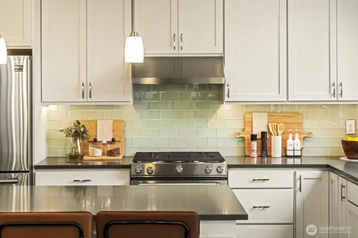 featuring expansive island, quartz countertops and premium appliances