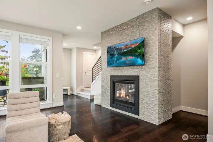 Sleek upgraded tile gas fireplace complements the modern living area