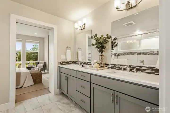 A spacious double vanity with dual sinks provides a massive amount of cabinet and drawer space and keeps everything organized and counters clean