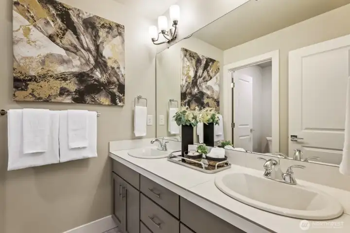 3rd floor main bathroom featuring upgraded tile, including shower tile walls all the way to the ceiling and tile counters.