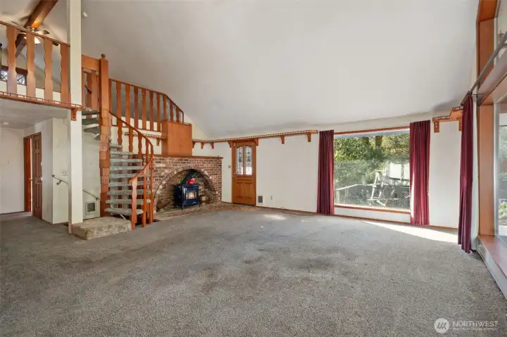 Great Room features a freestanding natural gas stove. Hand built circular stairway to loft.