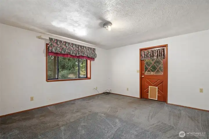 Lower floor bedroom #2 with walkout door to pool area.
