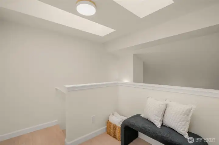 Large workspace flooded with natural light from skylights above; perfect for desk, office or space for hobbies.