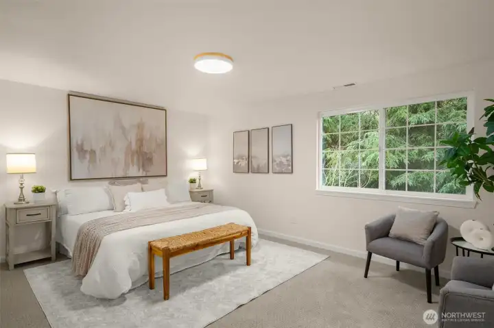 Oversized primary suite with seating space, multiple closets, walk-in closet, and 5-piece bath. Added privacy from mature trees.