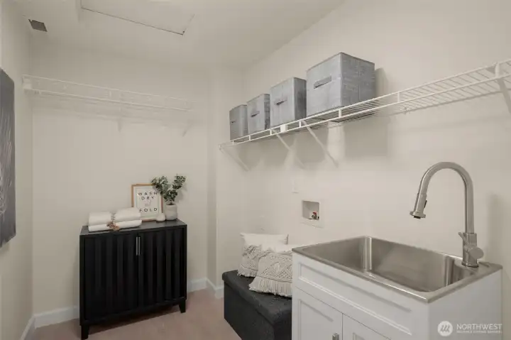 Full size laundry room conveniently situated between bedrooms for easy living