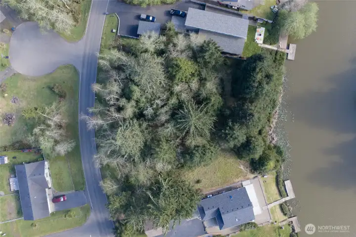 Parcel for sale is in between two other vacant lots.