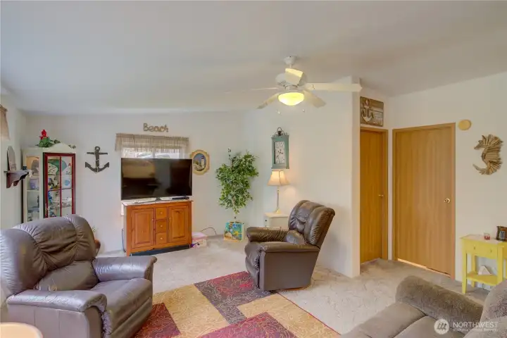 Living room from front entrance.  Door on left is 2nd bedroom. Door on right is a full bathroom.
