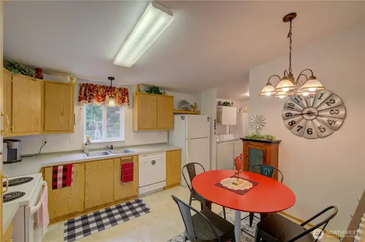Eat in Kitchen from the living room looking toward the utility room and back entrance.