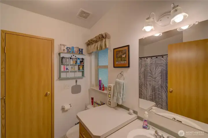 Primary bath.  Door leads to utility room and back entrance.