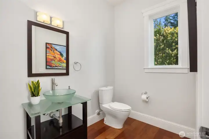 The main level has a 1/2 bath with a glass vessel sink. The main level has a 1/2 bath with a glass vessel sink.