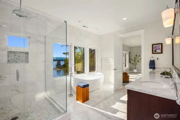 Heated marble floors, walk-in glass surround shower and heated towel bars are a few touches of the luxury in the primary bath. Heated marble floors, walk-in glass surround shower and heated towel bars are a few touches of the luxury in the primary bath.