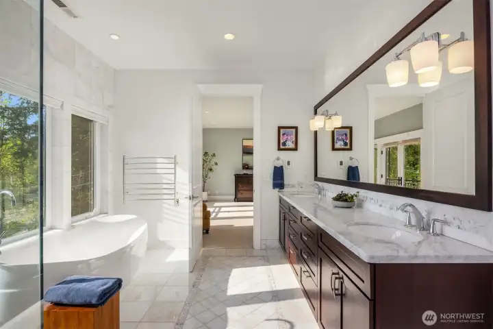 Double sinks sit on top of marble counters with plenty of storage below. Double sinks sit on top of marble counters with plenty of storage below.
