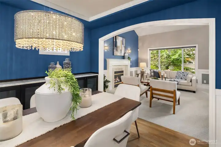 Dining room flows seamlesly into living room framed with picture windows