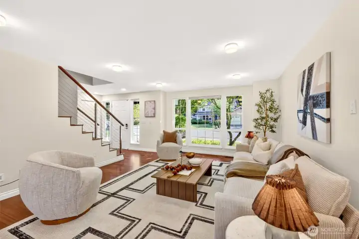 Oversized front windows pour natural light across the gleaming hardwood floors, framing leafy views and bringing the outdoors in. Updated dimmable LED lighting lets you fine-tune the mood from morning coffee to evening wind-down.