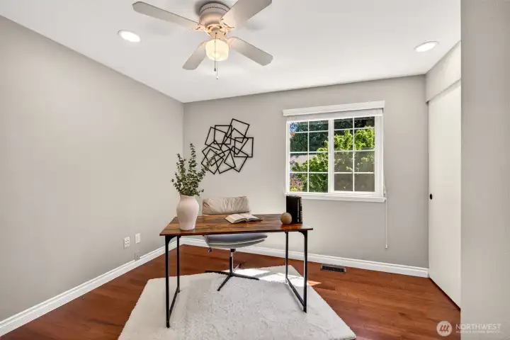 The third upper-level bedroom is currently set up as a quiet home office and works equally well for guests, a nursery, or a creative studio. Hardwood floors, a ceiling fan, and abundant natural light make this a flexible space ideal for the work-from-home professional or growing family.