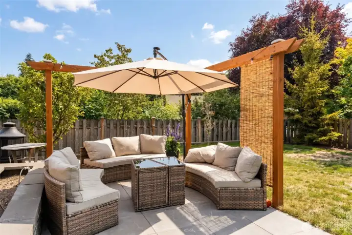 Step out to a generous concrete patio designed for Pacific Northwest indoor-outdoor living, with a cedar pergola anchoring one corner and complete privacy from the fully fenced perimeter. Whether you envision morning coffee, weekend barbecues, or evening conversation under the stars, the layout adapts to however you love to spend time outside. (Previously staged)