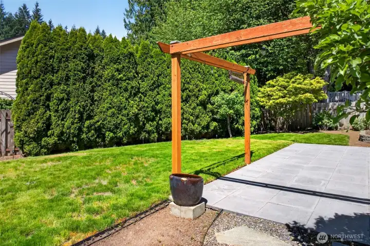 The fully fenced backyard combines an open lawn for play, a cedar pergola entry, a wide concrete paver patio, and a towering evergreen hedge that creates total privacy from neighboring properties. Mature landscaping, a charming Japanese maple, and an updated south-side fence and gate make this a turnkey outdoor retreat in the heart of English Hill.