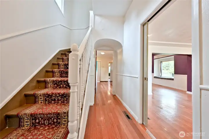 Entry way hall to kitchen, door to living room and stairs to second floor.