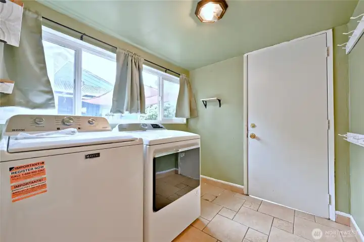 Utility/mud room with access to backyard garage, alley, driveway and shed.
