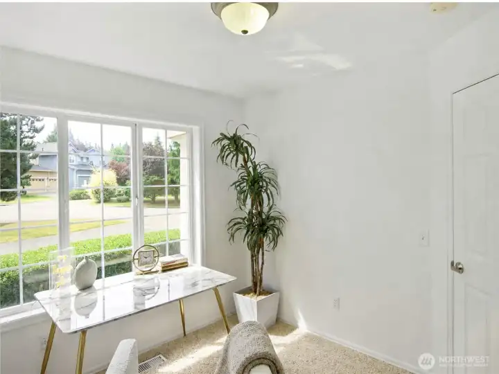 Main floor bedroom that offers versatile use as an office, ideal for guests or accessible living.