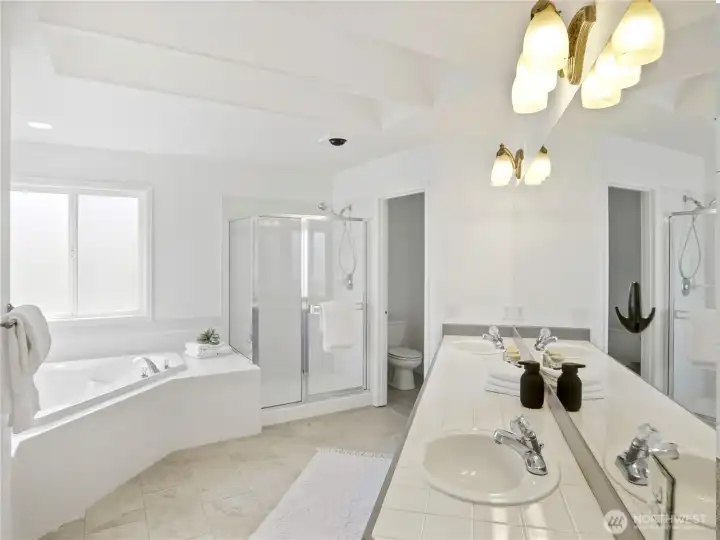 Spacious ensuite with a soaking tub, double sink and walk-in closet—perfectly private and beautifully refreshed.