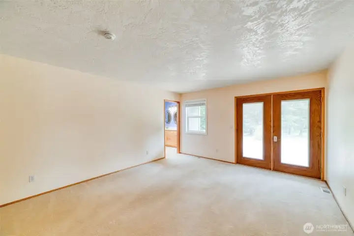 Primary bedroom with doors out to the deck Primary bedroom with doors out to the deck