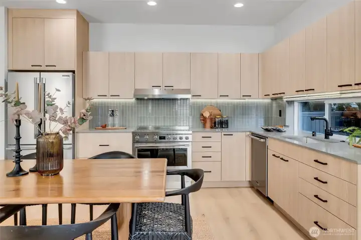 Bright, modern kitchen w/soft-close cabinets, luxury appliances & clean, minimalist design. Beautiful custom cabinets along with detailed tile work, black matte sink fixtures, and warm quartz counters complete an inspiring and inviting space for creating. Bright, modern kitchen w/soft-close cabinets, luxury appliances & clean, minimalist design. Beautiful custom cabinets along with detailed tile work, black matte sink fixtures, and warm quartz counters complete an inspiring and inviting space for creating.