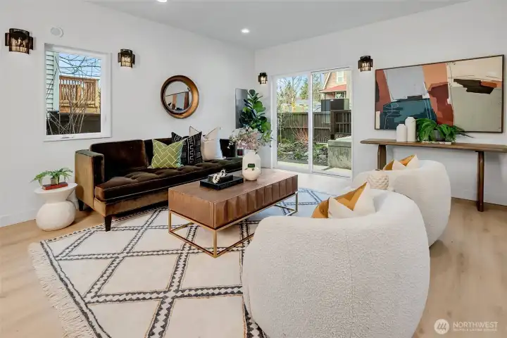 Sunlit living space enhanced by custom lighting and light flooring that creates striking contrast. Sunlit living space enhanced by custom lighting and light flooring that creates striking contrast.