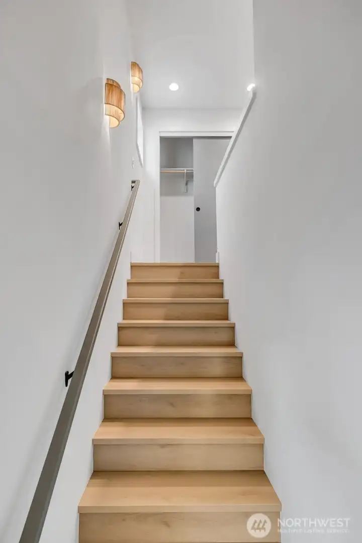 Custom sconces light the path up the stairs to upper levels.Additional storage also located at the top of the stairs. Custom sconces light the path up the stairs to upper levels.Additional storage also located at the top of the stairs.