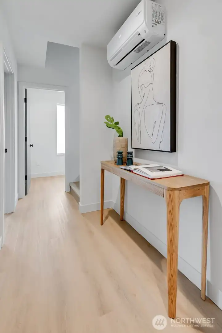Sleek mid-level landing in this new-build home, houses the laundry room conveniently located on the second floor. Sleek mid-level landing in this new-build home, houses the laundry room conveniently located on the second floor.