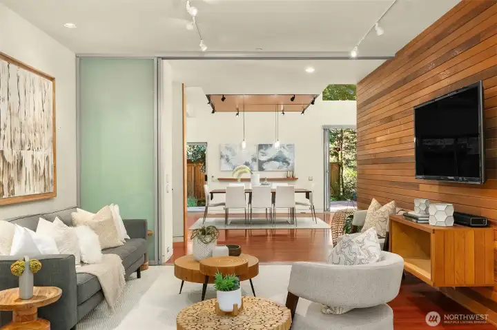 Translucent sliding panels let the family room close off from the main living areas or open to them entirely — flexibility that suits everything from movie nights to overflow entertaining.