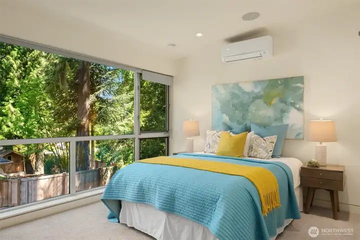 Corner windows wrap this bedroom in canopy views, bringing the treehouse feeling to the private spaces upstairs.