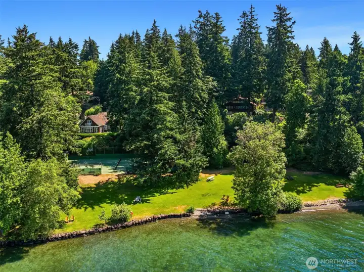 The WABA community beach, moorage, and sport court sit at the foot of the village — a private waterfront park shared by fewer than 300 residents.